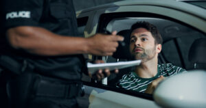 Man, police and stop car for fine, registration check and speeding for traffic warning. Person, law enforcement and licence for drunk driving, ticket penalty and transport risk for violation at night.
