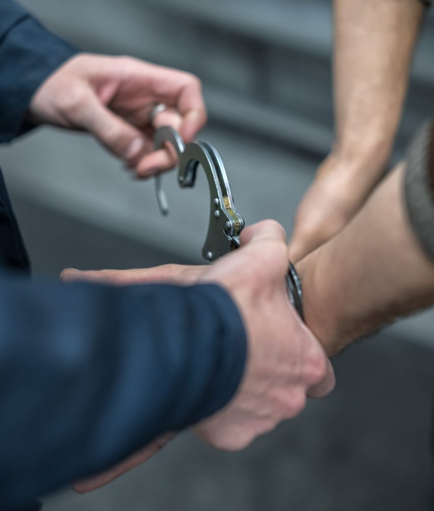 handcuffs on the prisoner. Making an arrest. Remand in custody